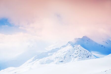 Snow storm in the mountains at sunset. Beautiful winter landscape.の写真素材