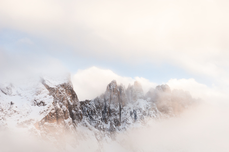 Mountain peaks in the clouds. Winter landscape in Dolomites, Italyの写真素材