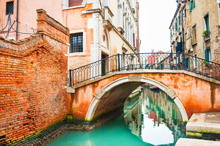 Scenic canal with ancient buildings and bridge in Venice, Italy.の写真素材