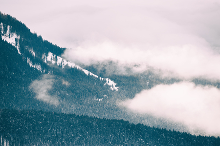 Foggy morning in the winter mountains. Dolomite Alps, Italy. Vintage filterの写真素材