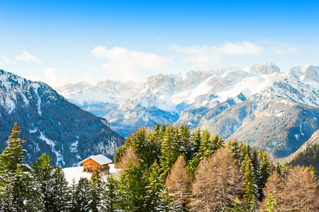 Wooden house in Dolomite Alps in winter, Val di Fassa, Italyの写真素材