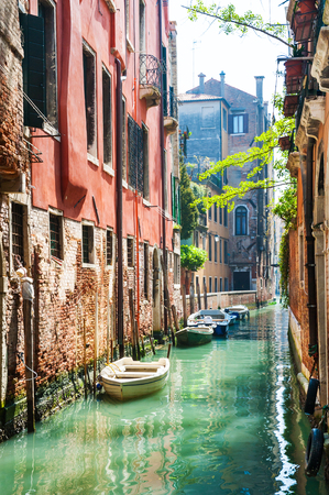 Scenic canal with old buildings in Venice, Italy.の写真素材