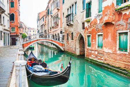 Scenic canal with bridge and gondola in Venice, Italy.の写真素材