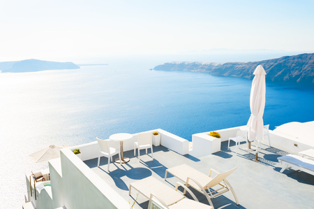 Chaise lounges on the terrace with sea views. Santorini island, Greeceの写真素材