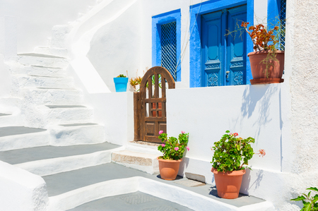 Traditional greek white architecture with blue doors and windows. Santorini island, Greece.の写真素材