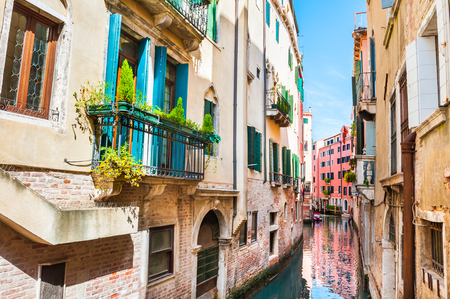 Scenic canal with old buildings in Venice, Italy.の写真素材