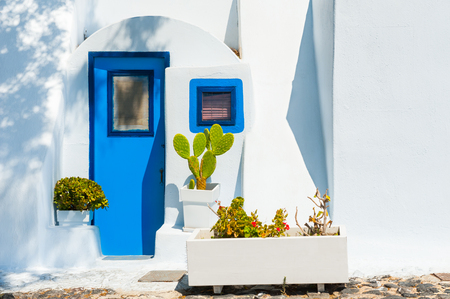 Traditional greek white architecture with blue doors and windows. Santorini island, Greece.の写真素材