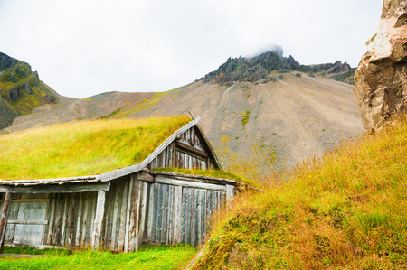 Traditional icelandic house with grass roof in the mountains. Southern Icelandの写真素材
