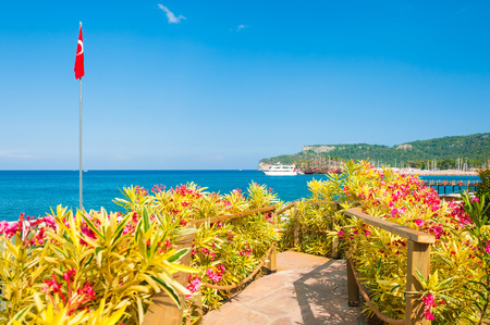 Beautiful beach with flowers in Kemer, Turkey. Summer landscape, travel and vacationの写真素材