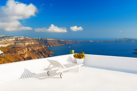 Chaise lounge on the terrace overlooking the sea. Santorini island, Greeceの写真素材