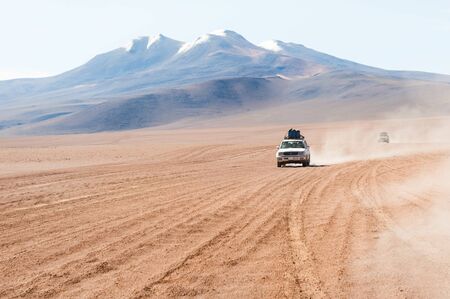 Altiplano, Bolivia - March, 28, 2017: Off-road cars driving in the desert of plateau Altiplano, Boliviaのeditorial素材