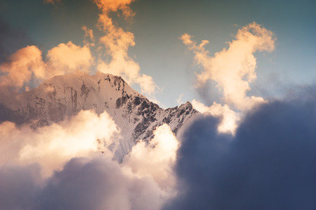 Himalaya mountain peaks with clouds against the sky at sunset. Khumbu valley, Himalayas, Everest region, Nepalの写真素材