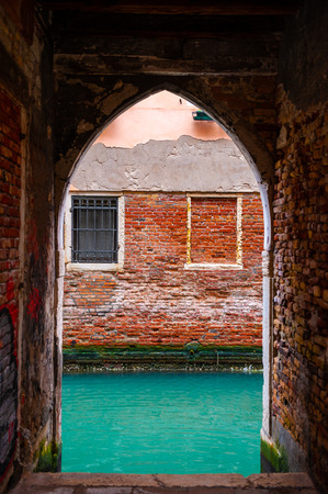 View of canal from arch of the building in Venice, Italy.の写真素材