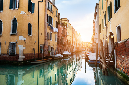 Scenic canal with old architecture at sunset in Venice, Italy.の写真素材