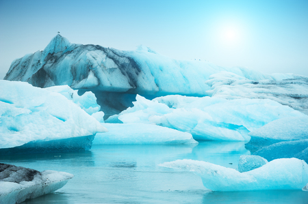 Blue icebergs in Jokulsarlon glacial lagoon at sunset, southern Icelandの写真素材