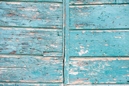 Wooden door with shabby paint, grunge texture backgroundの写真素材