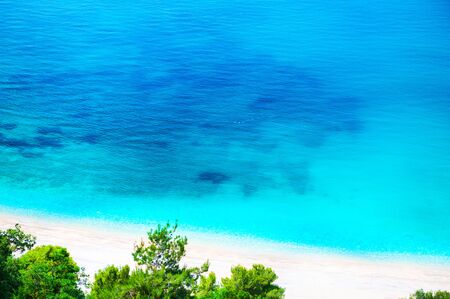 Beautiful sea beach with white sand and turquoise water. Adriatic sea, Montenegro. Summer travel background,の写真素材