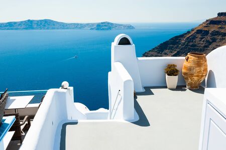 White architecture on Santorini island, Greece. Beautiful terrace with sea view. Famous travel destinationの写真素材