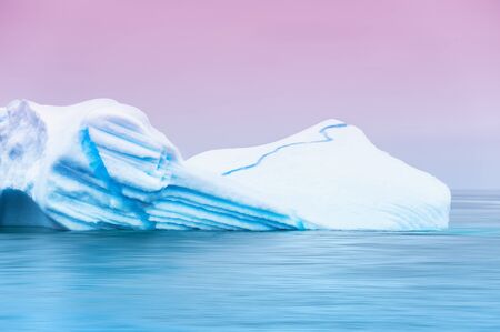 Beautiful iceberg in the Atlantic ocean at sunset. Ilulissat ice fjord, western Greenlandの写真素材