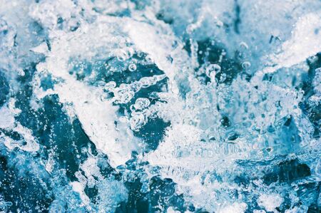 Blue ice on the frozen lake. Macro image, shallow depth of field. Winter nature backgroundの写真素材