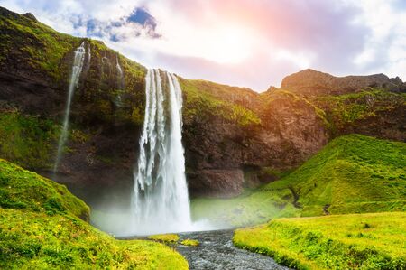 Seljalandsfoss waterfall in Iceland at sunset. Beautiful summer landscape. Famous travel destinaationの写真素材