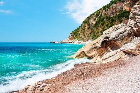 Beautiful beach with turquoise water and cliffs near Petrovac, Montenegro. Travel and vacationの写真素材