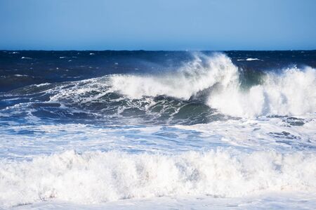 Big blue ocean wave crashing near the coast. Beautiful nature background