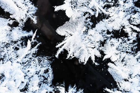 White hoarfrost on the surface of ice on the lake. Macro image. Beautiful winter nature backgroundの写真素材