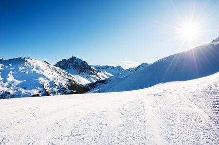 Ski slopes in ski resort in winter Alps. Meribel, 3 Valleys, France. Beautiful mountains and the blue sky, winter landscapeの写真素材