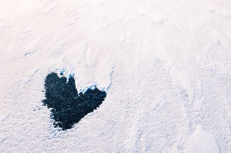 Shape of heart with snow and ice. Abstract winter nature backgroundの写真素材