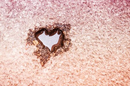 Shape of heart with water on the stone surface. Abstract love backgroundの写真素材