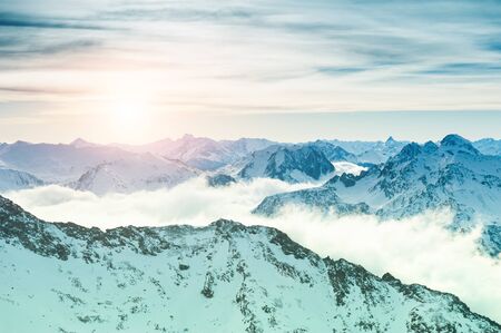 Beautiful Alps mountains with clouds at sunset, winter landscape. Val Thorens, 3 Valleys, France.の写真素材