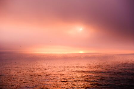 Beautiful sunset in Atlantic ocean near the coast of Algarve, Portugal. Colorful nature backgroundの写真素材