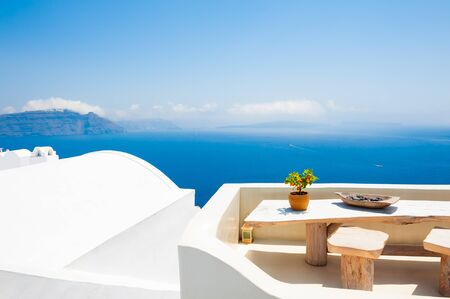 White architecture on Santorini island, Greece. Beautiful terrace with sea view. Travel destinations concept