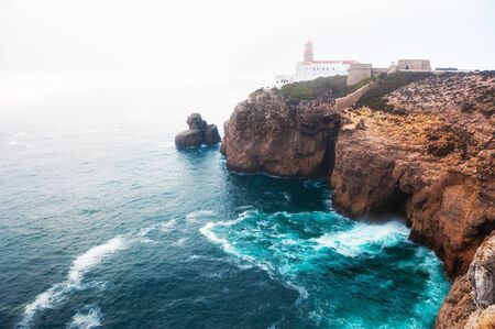 Lighthouse on Cape St. Vincent in foggy evening in Algarve, Portugal. This is the most South-Western point of Europeの写真素材