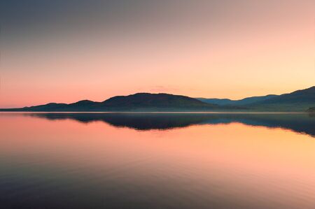 Lake in the mountains at sunset. Beautiful summer landscape. South Ural, Russiaの写真素材