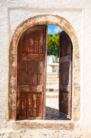 Old wooden door of the house. Traditional greek architecture on Santorini island, Greece.の写真素材