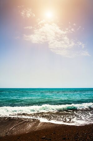 Beautiful beach with black sand and turquoise sea at sunny day. Red beach on Santorini island, Greece.の写真素材