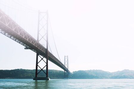 25th April Bridge on Tejo river at misty day in Lisbon, Portugal. Summer landscape. Famous travel destinationの写真素材