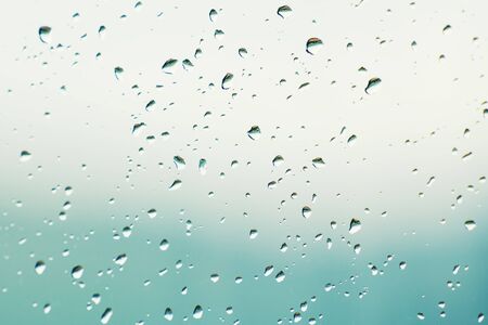 Raindrops on the window glass surface. Selective focus. Abstract blurred background.の写真素材