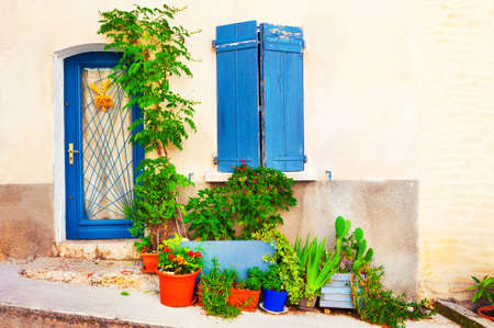 Old architecture in Valensole, Provence, France. Facade of the house with flowers in the potsの写真素材