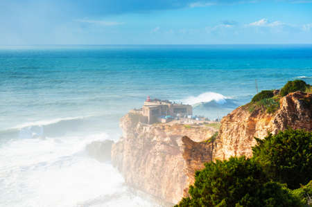 Big waves on the coast of Atlantic ocean in Nazare, Portugal. In this place the biggest waves in the world due to the underwater canyonの写真素材