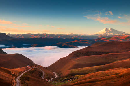 View of Elbrus mount at sunrise from Gil-Su valley in North Caucasus, Russia. Beautiful autumn...