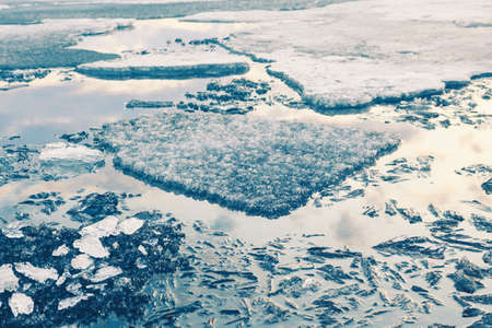 Melting ice on the shore of lake. Macro image, shallow depth of field. Beautiful nature background