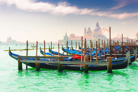 Gondolas on the Grand canal in Venice, Italy. Basilica Santa Maria della Salute in the background. Famous travel destination.の写真素材