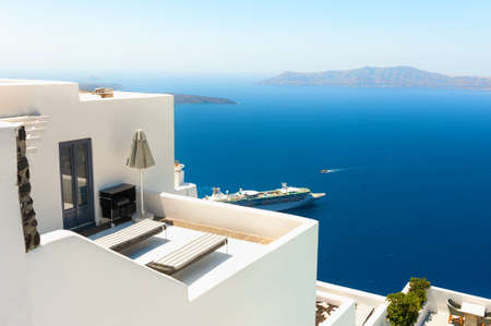 White architecture on Santorini island, Greece. Beautiful terrace with sea view. Famous travel destinationの写真素材