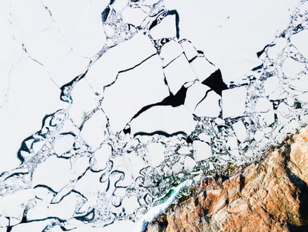 Melting ice on the shore of Baikal lake in spring. Aerial drone view. Baikal lake, Siberia, Russia