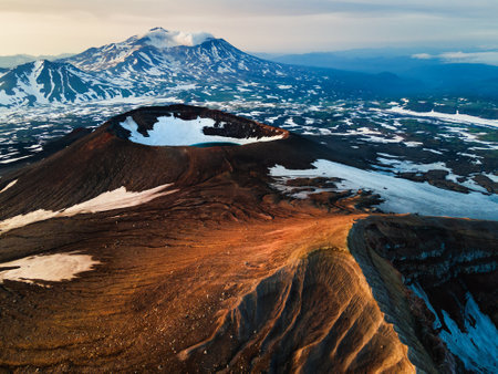 Crater of Gorely volcano and Mutnovsky volcano in the background. Kamchatka peninsula, Russia....