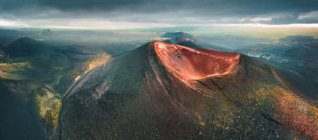 Volcano craters and black lava fields of Tolbachik volcano in Kamchatka peninsula, Russia. The Northern craters of Tolbachik volcano eruption of 1975. Aerial panoramic viewの写真素材