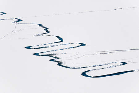 Ice with snow on the lake. Aerial drone view. Abstract nature background. Baikal lake, Siberia, Russia.の写真素材